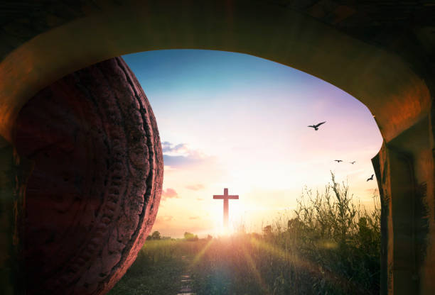 istock Easter concept: Tomb stone with holy cross and sunset sky background 1282607762