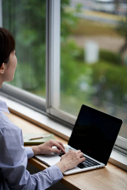 istock A young woman operating a computer by the window 1282607844