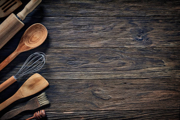 istock Top view of wooden kitchen utensils on rustic table with copy space. 1282607922