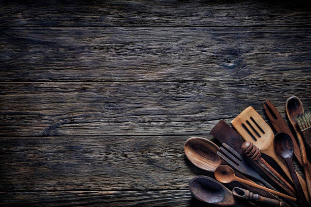 istock Top view of wooden kitchen utensils on rustic table with copy space. 1282608458
