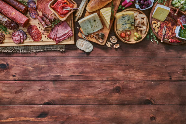 istock Tapas of cured ham and cheese delicious appetizer on rustic wood table with copy space 1282609212
