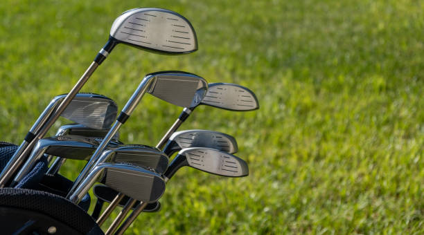 istock Golf sticks on green grass golf course, close up view. 1282613207