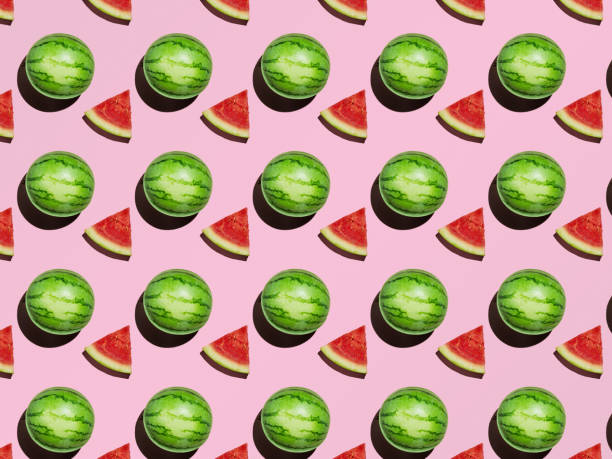 istock Pattern Mini Watermelon and slices on a pink background with a hard shadow 1282614138