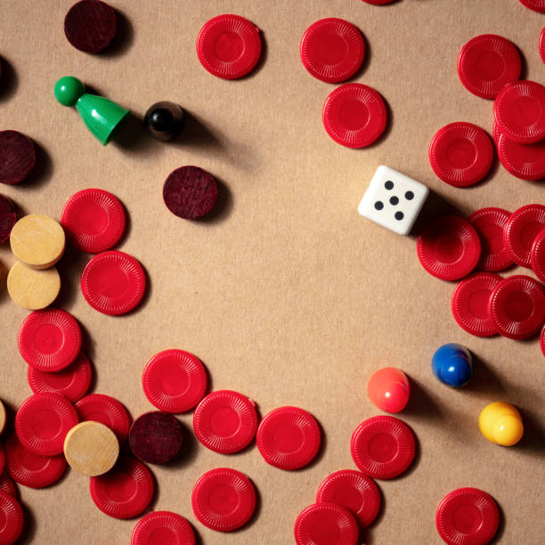 istock Board games square frame, a flat lay with various pieces and a die, with a place for text 1282617174