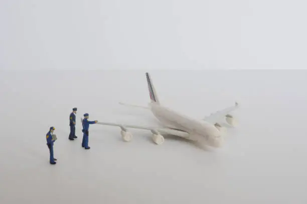 A miniature police officer monitoring a super-large aircraft