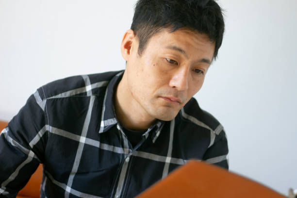 istock Adult man reading studiously 1282626083