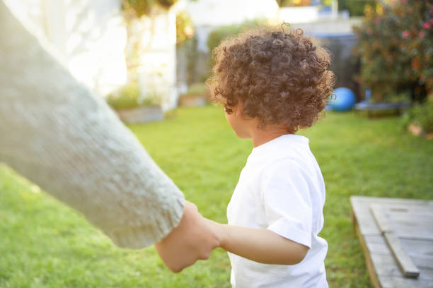 istock Cuttle cute boy is pulling his moms hand 1282631370