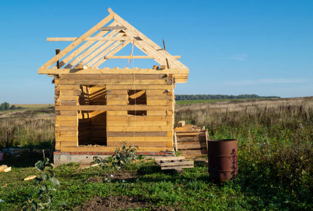 istock Construction of the wooden building from bar on background sky 1282632400