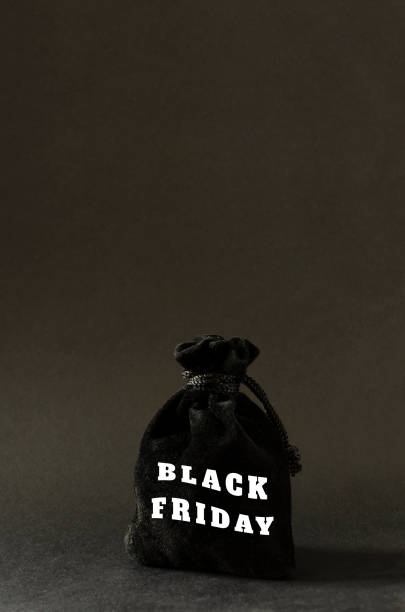 istock Vertical image.Black cloth bag and text Black Friday on it.Dark background and empty space 1282636141