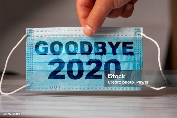 Hand Holds A Medical And Protective Mask With The Word Goodbye 2020 Concept Of Coronavirus Quarantine Prevent Or Stop The Spread Of The Covid19 Worldwide Stock Photo - Download Image Now