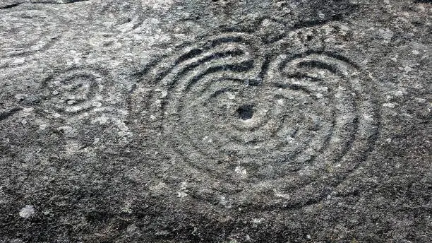 Rock with petroglyphs decoration and ancestral art of Mordor, Pontevedra province, Galicia, Spain, set in early Bronze Age. There is an interpretation center nearby but the Petroglyphs themselves are of public free access.