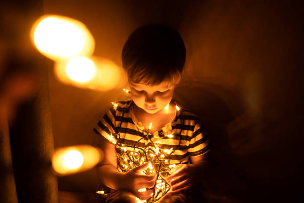 istock Baby boy with garland in dark. 1282641878