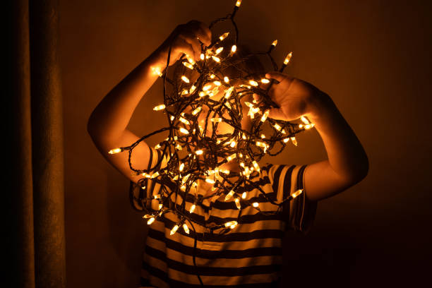 istock Baby boy with garland in dark. 1282641879