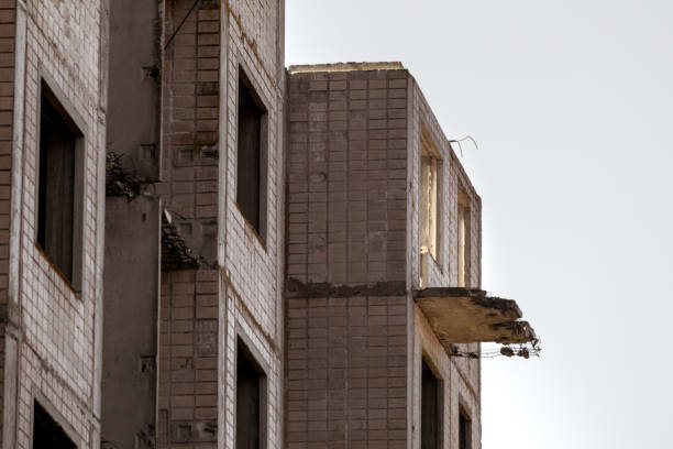 The remains of the frame of a large concrete building close-up. The impact of the destruction. Background.