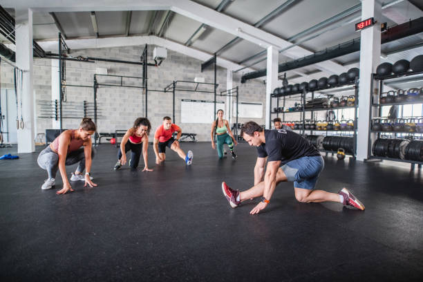 istock Gym Coach and Athletes Doing Kneeling Hamstring Stretch 1282647849