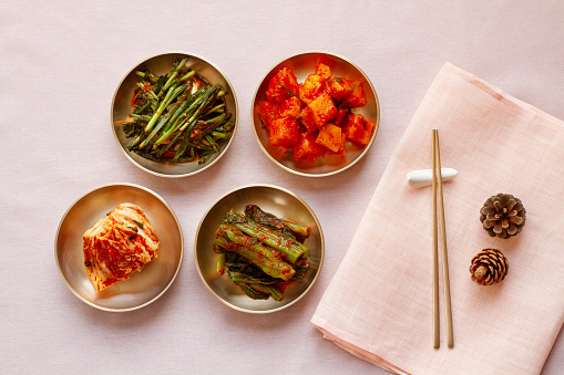 The most famous Korean food Kimchi (napa cabbage, leaf mustard, turnip, leek) in high quality brass tableware. Top view.