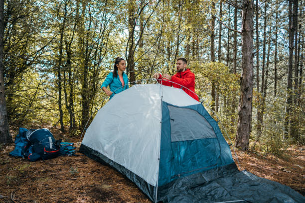 istock Young couple setting up a tent 1282648728