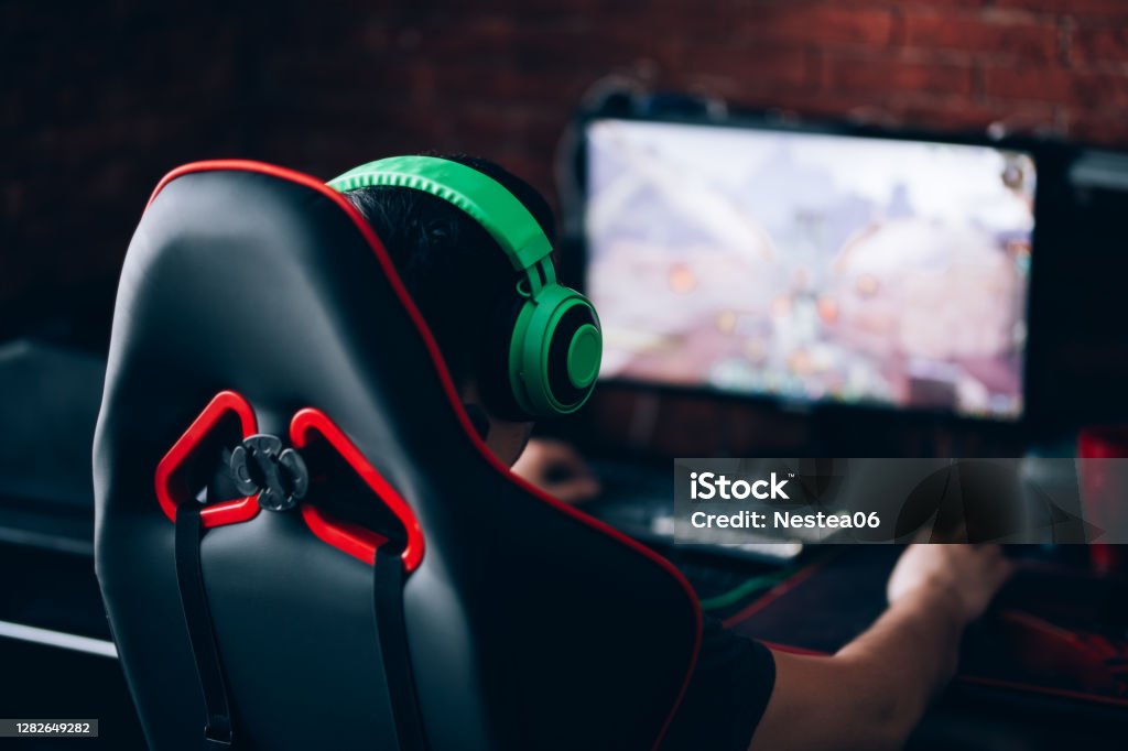 computer games, playing place computer games, playing place, young gamer plays computer games with headphones, Video Game Stock Photo