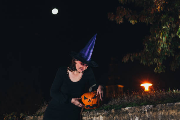 istock Witch holding pumpkin 1282650080