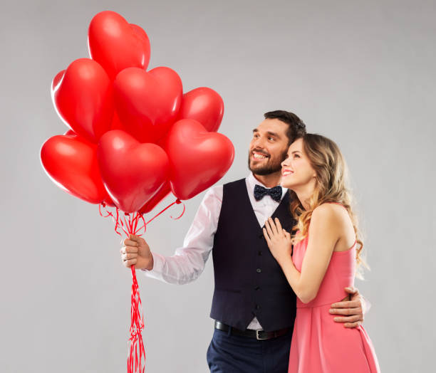 istock happy couple with red heart shaped balloons 1282651878