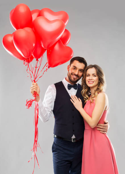 istock happy couple with red heart shaped balloons 1282652618