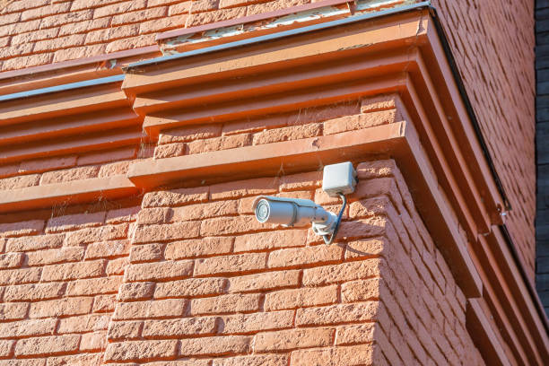 istock Small security camera on the stone wall 1282654144