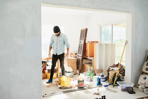Shot of a young man renovating a house