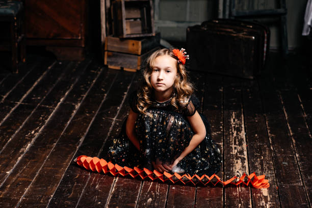 istock A sad child sits on the floor in a dark room. 1282656066