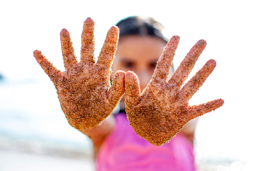 Little girl playing with sands