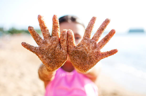 Little girl playing with sands