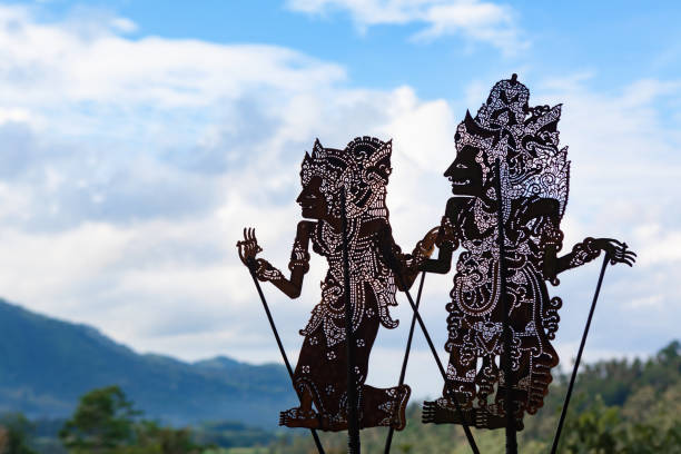 Black shadow silhouette of traditional Balinese puppets Wayang Kulit Black shadow silhouette of old traditional puppets of Bali Island - Wayang Kulit. Culture, religion, Arts festivals of Balinese and Indonesian people. Travel background wayang kulit stock pictures, royalty-free photos & images