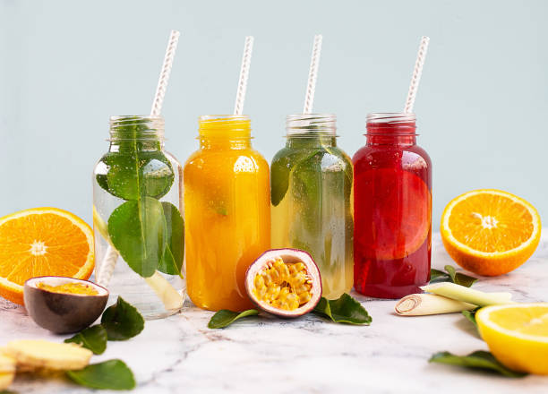 istock Natural lemonade with fruits on blue background 1282657761