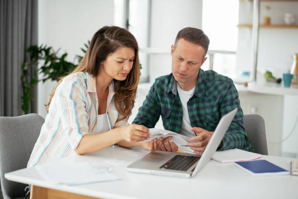 istock Husband and wife preparing bills to pay. 1282662913