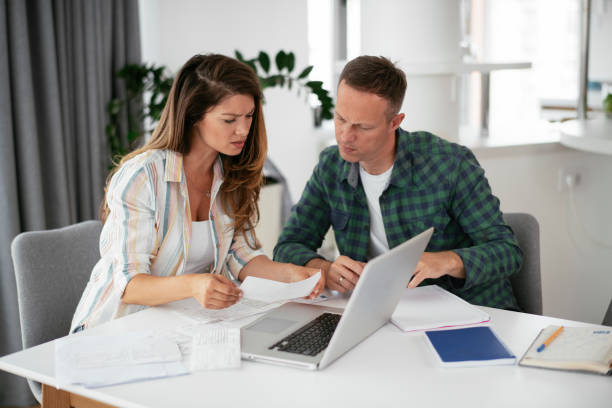 istock Husband and wife preparing bills to pay. 1282663338