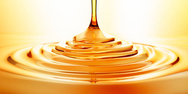 flow of pouring oil or honey - syrup imagens e fotografias de stock