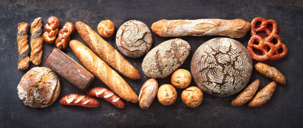 istock Delicious freshly baked bread assortment on dark rustic background 1282670061
