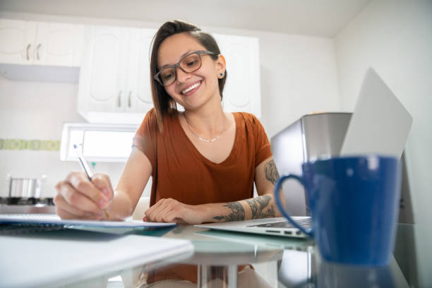 istock Happy woman studying online at home 1282671419