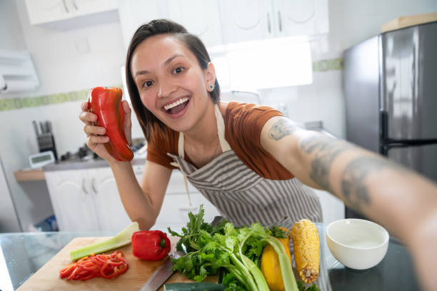 Food vlogger taking a selfie while cooking at home
