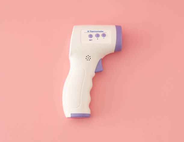 istock Digital Temperature Gun on pink background 1282672041