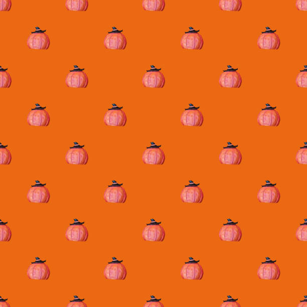 Background for halloween or for wrapping paper. Seamless pumpkin pattern on an orange background. An image of a pumpkin with a witch's hat. Grooves on the ceramic pumpkin