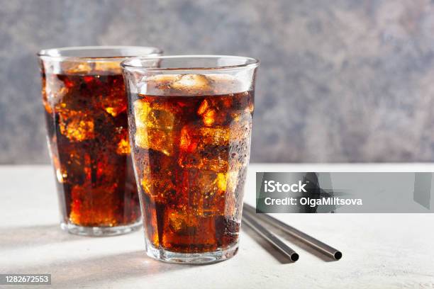 Glass Of Cold Cola Soft Drink With Ice On Wooden Background Stock Photo - Download Image Now