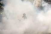 Protestor in tear gas cloud