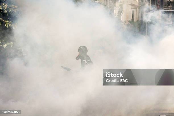 Protestor In Tear Gas Cloud Stock Photo - Download Image Now - Tear Gas, Protest, Protestor