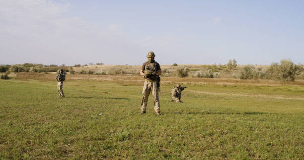 istock Soldiers protecting commander while surveilling enemy territory 1282678138