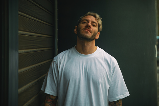 Portrait of handsome bearded men with blonde dyed hair wearing white t-shirt