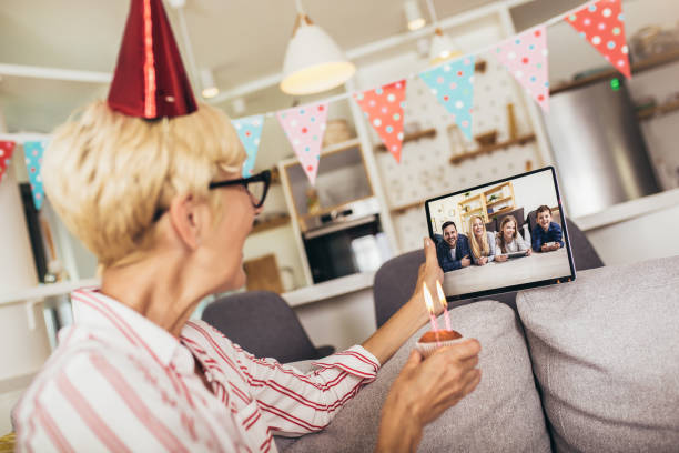 istock Senior woman alone at home having a celebration on a video call 1282679916