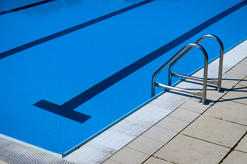 Empty modern swimming pool with stair