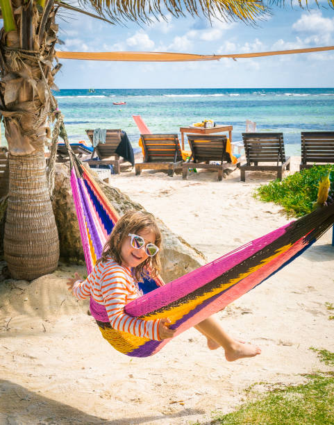 istock Cute kid in a colorful beachfront hammock wearing sunglasses 1282681665