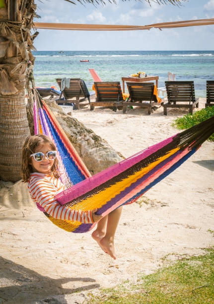 istock Cute kid in a colorful beachfront hammock wearing sunglasses 1282681666