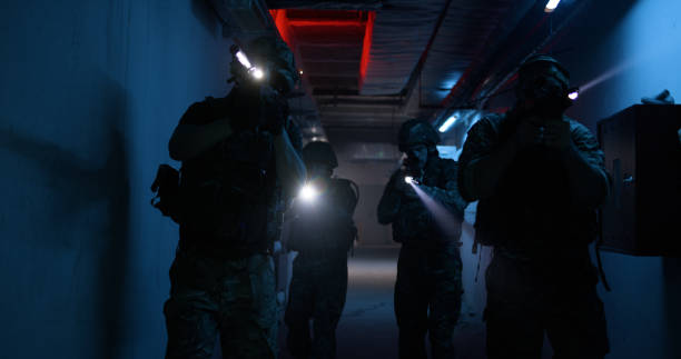 istock Soldiers with flashlights inspecting dark corridor 1282681895